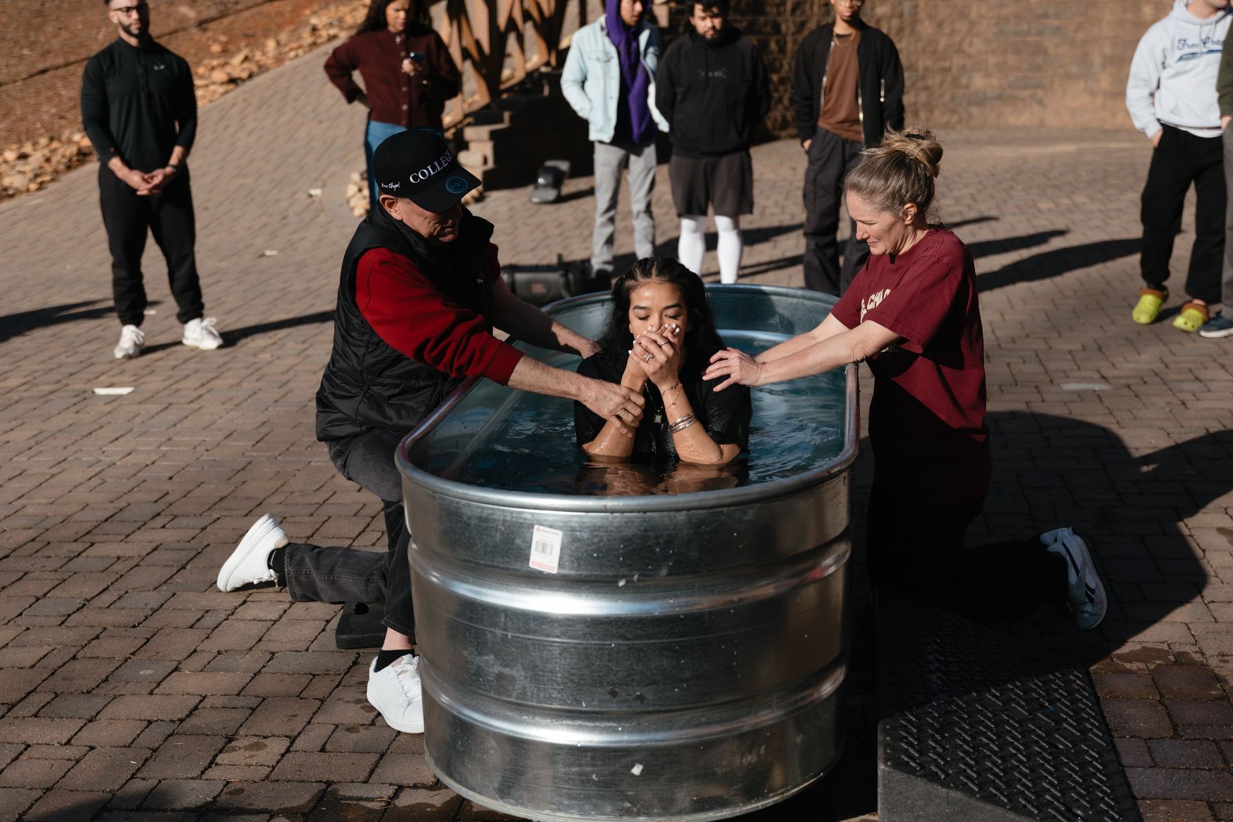 A student being baptized by Free Chapel College staff