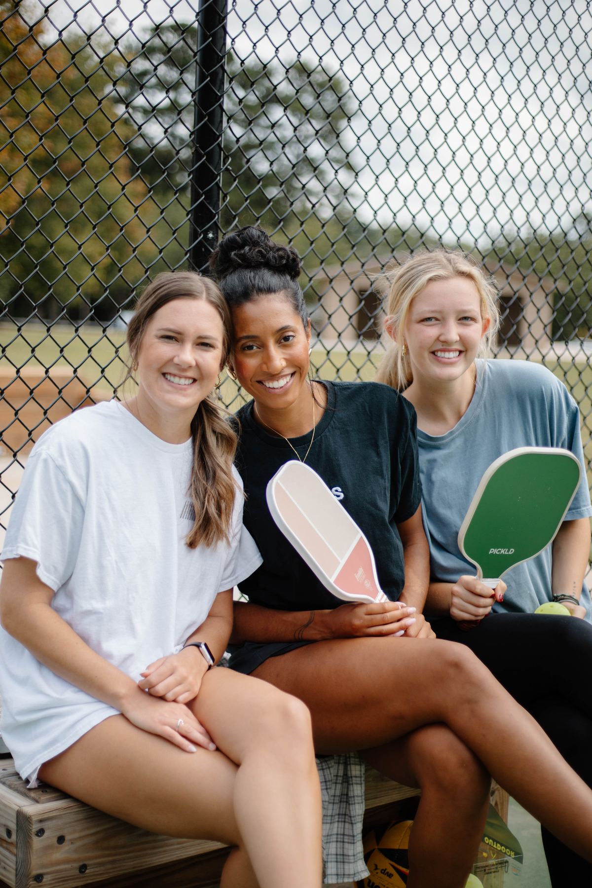 Students holding pickleball paddles